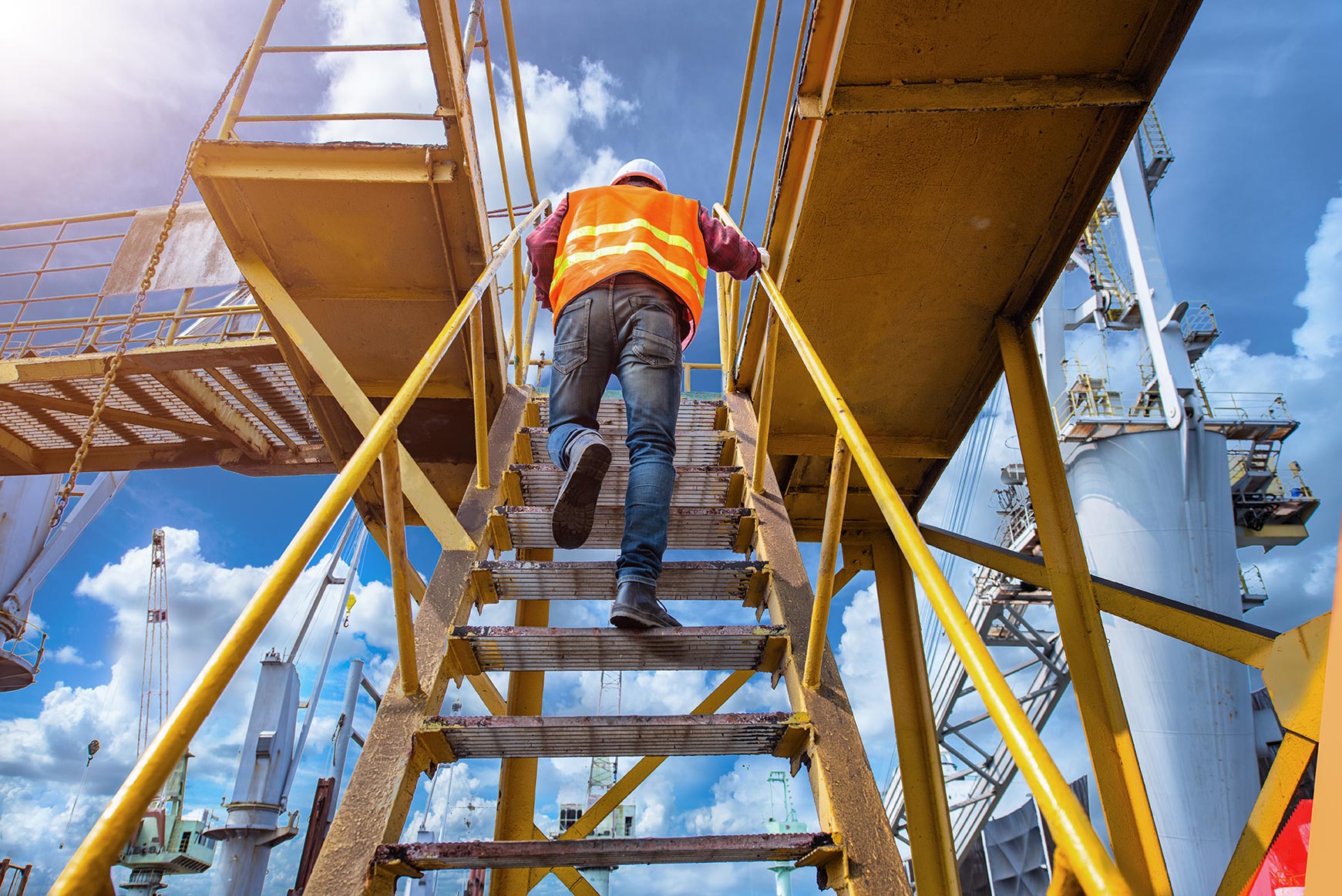 Health and Safety Training Experts. Man climbing a ladder